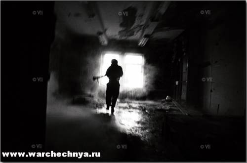 A Chechen fighter just after firing his RPG from inside a...