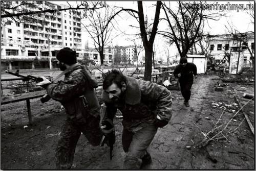 Chechen fighters running for cover in Grozny, January, 19...