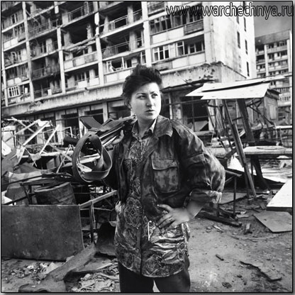 A woman fighter stands on a street in Grozny, Chechnya in...