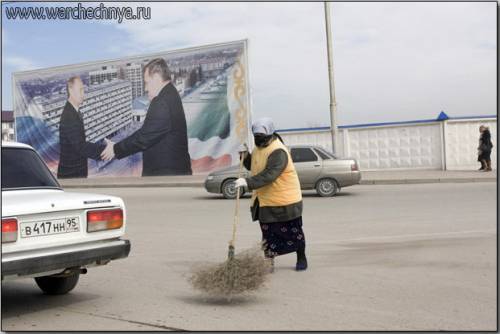 A woman sweeps the streets in the same area as the previo...